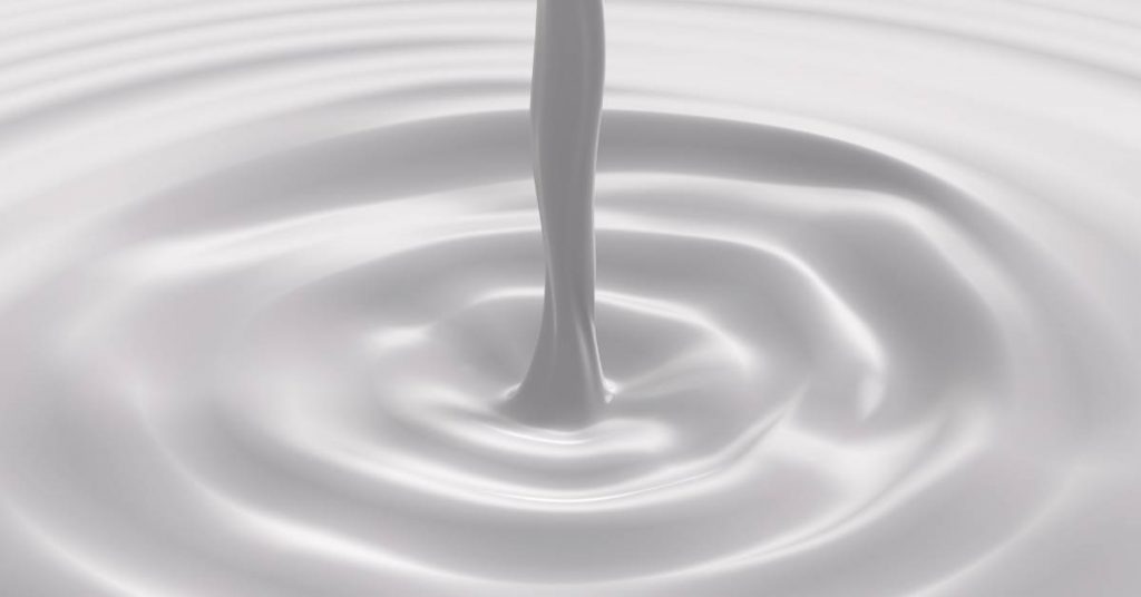 a glass of milk of magnesia creating ripples, illustrating a soothing liquid remedy for oral relief