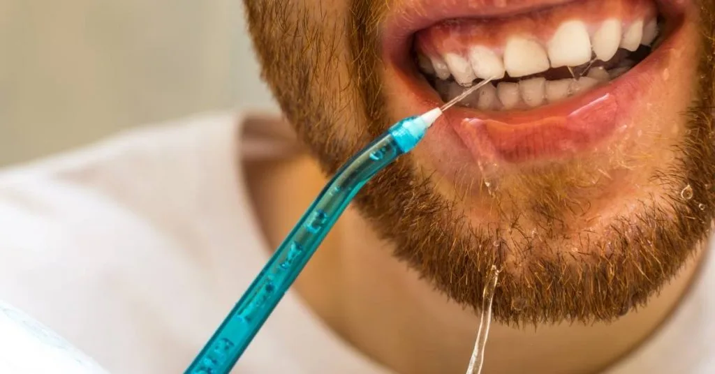How Long After A Deep Teeth Cleaning Can I Eat? & What You Can Eat! 2 a modern electric dental irrigator device with adjustable settings for post-cleaning oral hygiene care