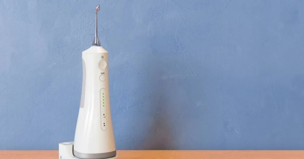 How Long After A Deep Teeth Cleaning Can I Eat? & What You Can Eat! 3 a modern electric dental irrigator device with adjustable settings for post-cleaning oral hygiene care