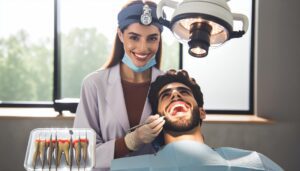 a dentist examining a patient’s mouth with dental tools while a dental light illuminates the area